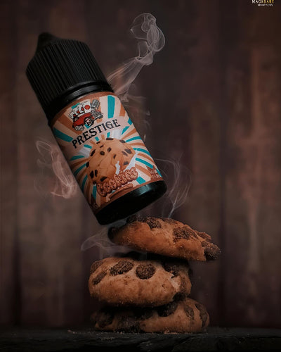 Prestige cookie-flavored vape juice bottle hovering above cookies with smoke effect on a dark background