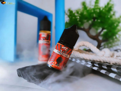 Prestige vape juice bottle on a textured surface with a blurred background