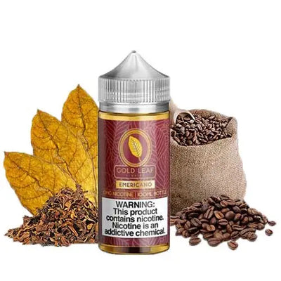 A bottle of Gold Leaf Nicotine EmERICANO flavor e-liquid centered on a white background, surrounded by decorative props including yellow tobacco leaves, loose tobacco pieces, a burlap sack of coffee beans, and scattered coffee beans.