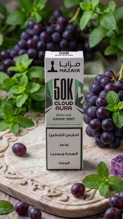 Mazaya 50K Cloud Aura vape juice box with grapes and mint leaves on a wooden surface